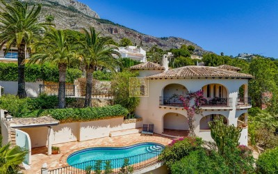 A beautiful villa in a peaceful, green setting.