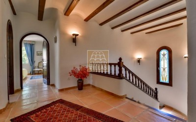 A beautiful villa in a peaceful, green setting.