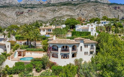 A beautiful villa in a peaceful, green setting.